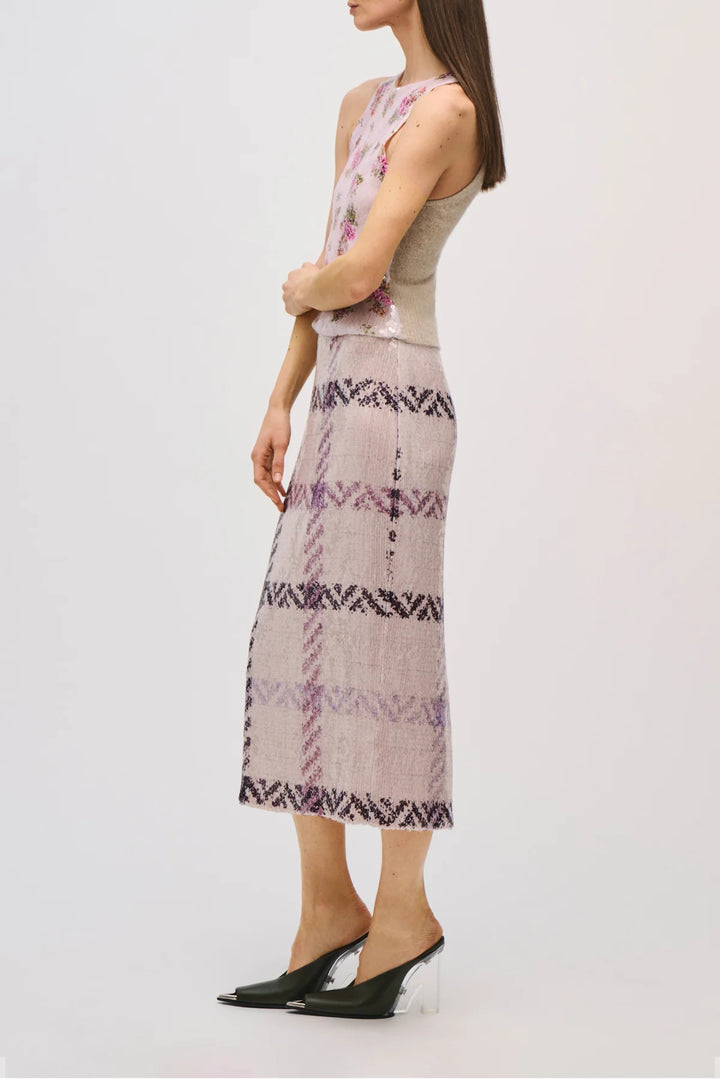 Woman wearing a patterned dress with a white background