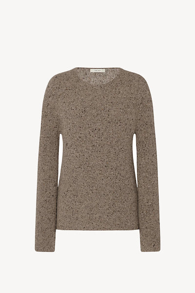 Brown speckled sweater on a light beige background