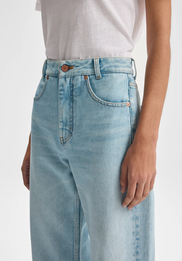 Light blue jeans worn by a person on a white background