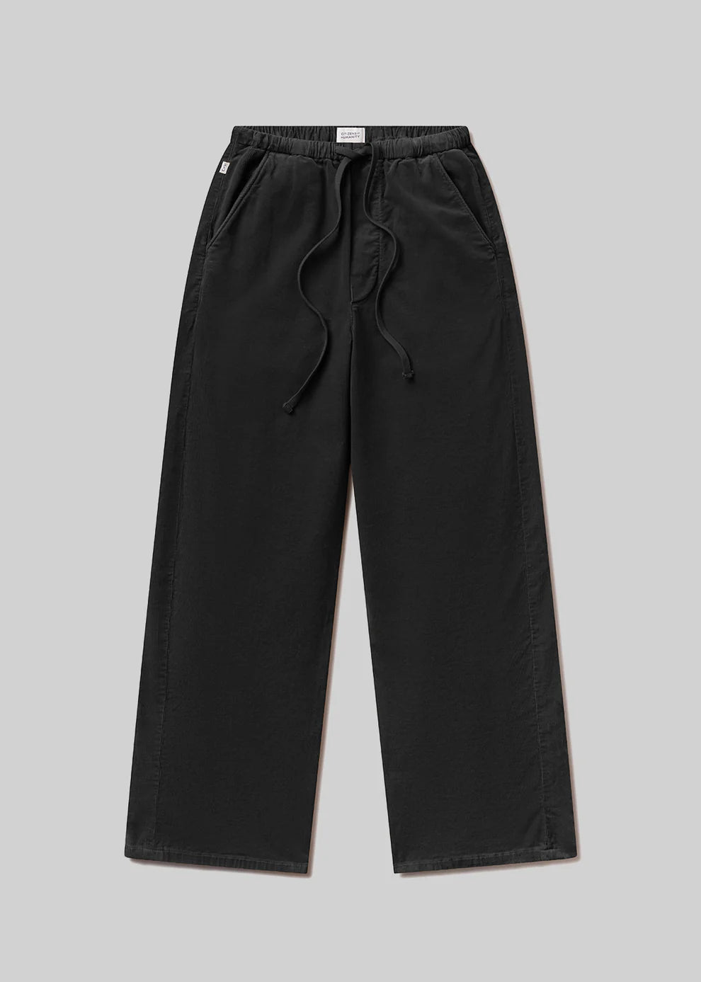 Black pants with drawstring on a gray background