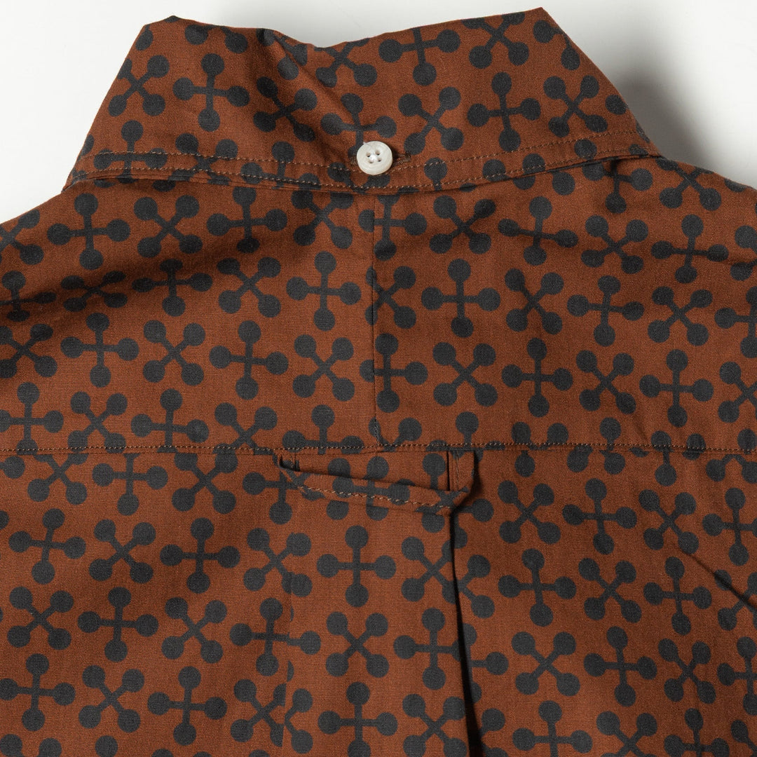 Brown shirt with black geometric pattern on a white background