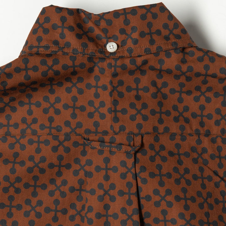 Brown shirt with black geometric pattern on a white background