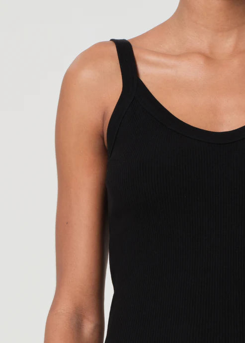 Black tank top worn by a person on a light gray background