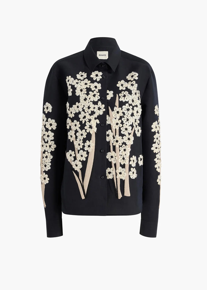 Black shirt with white floral patterns on a white background