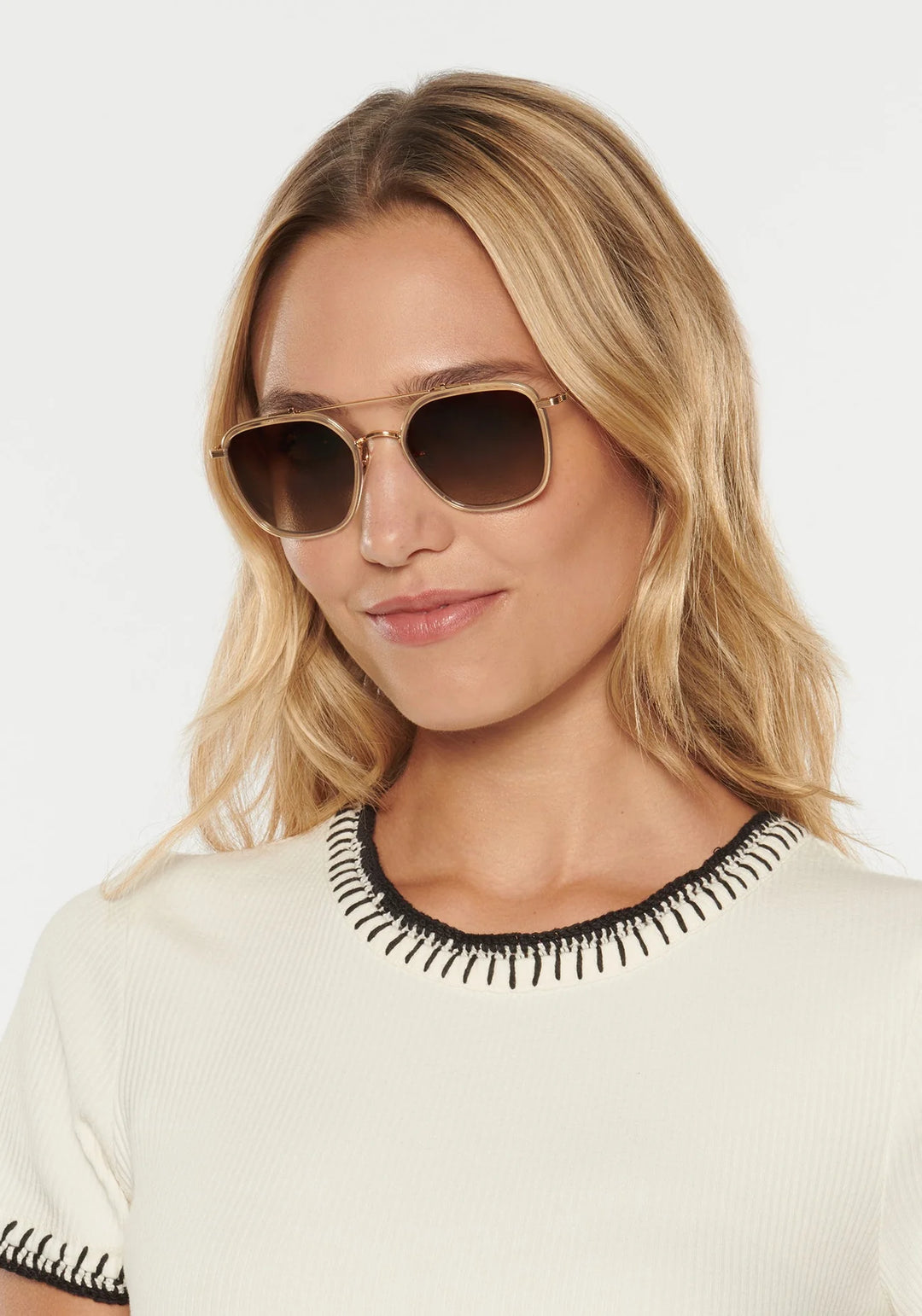 Woman wearing sunglasses with a plain background