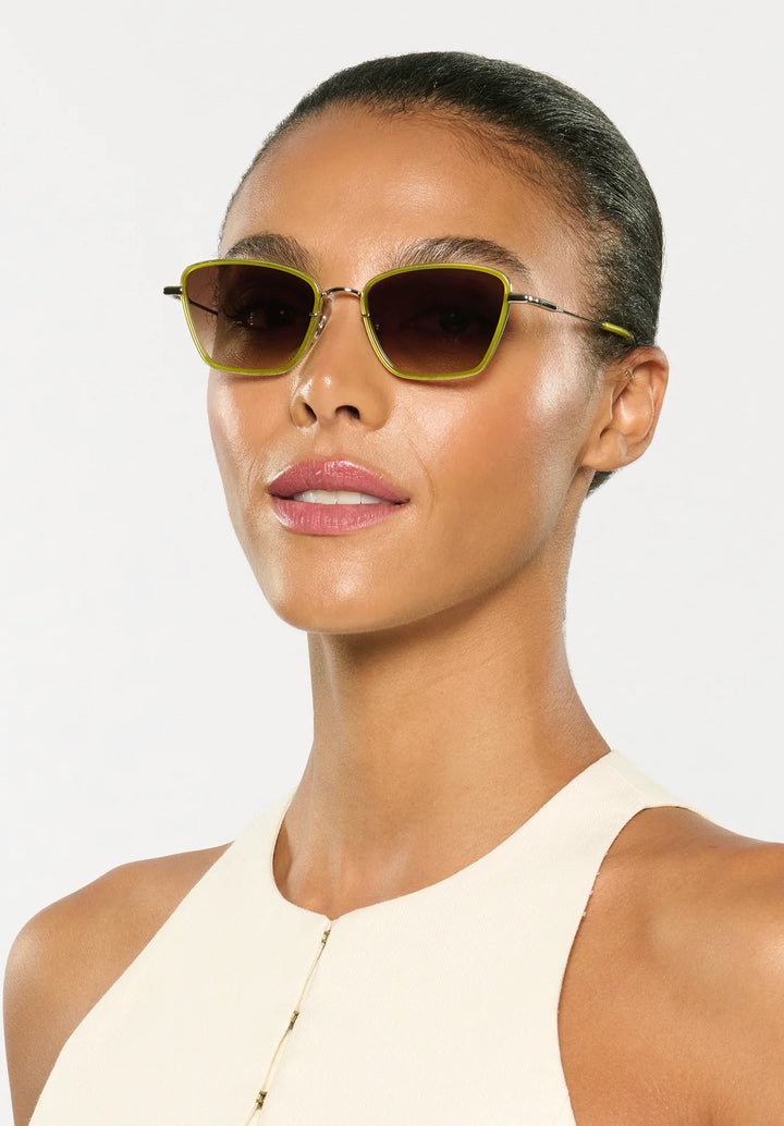 Woman wearing sunglasses with a plain background