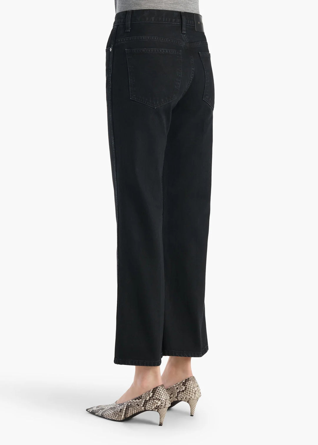 Black pants worn by a person on a white background