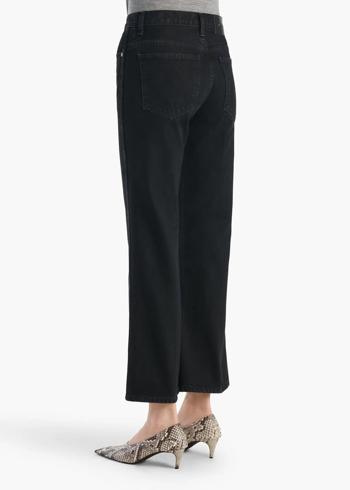 Black pants worn by a person on a white background