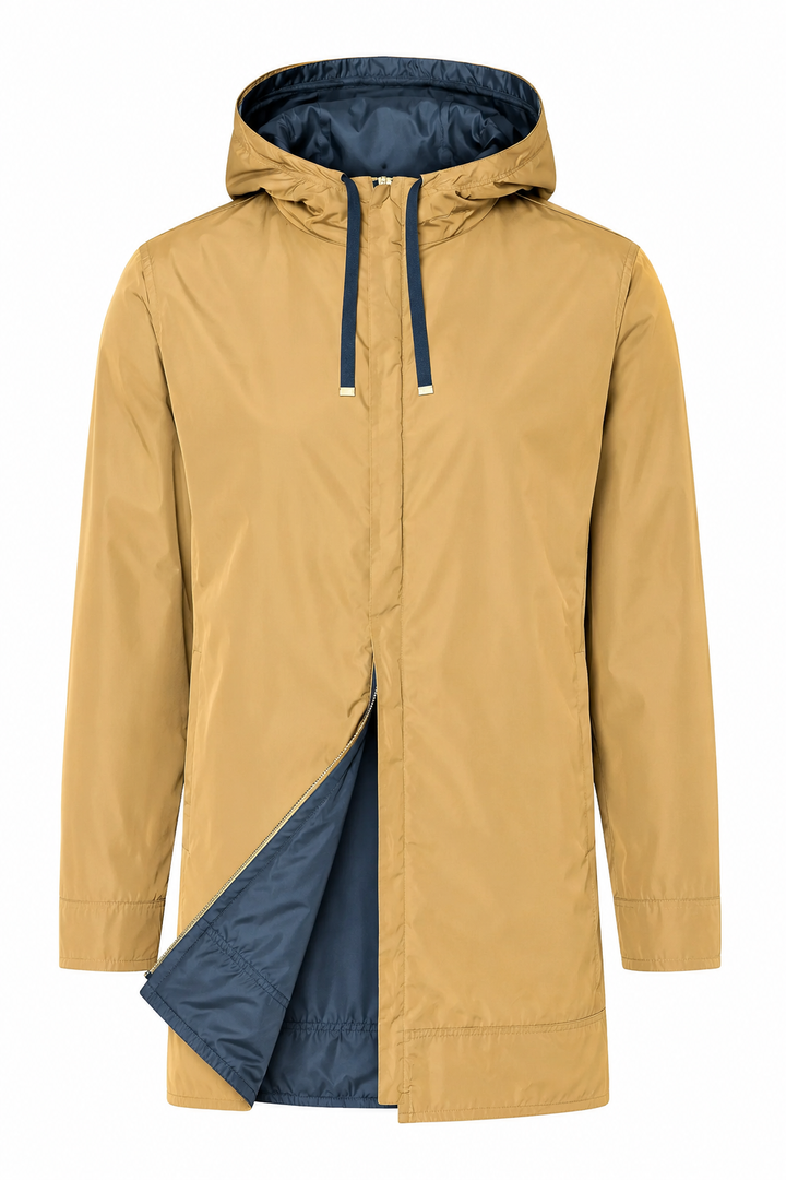 A hooded raincoat in a warm camel tan color, shown with the front zipper partially open to reveal a contrasting dark navy blue interior lining and hood.