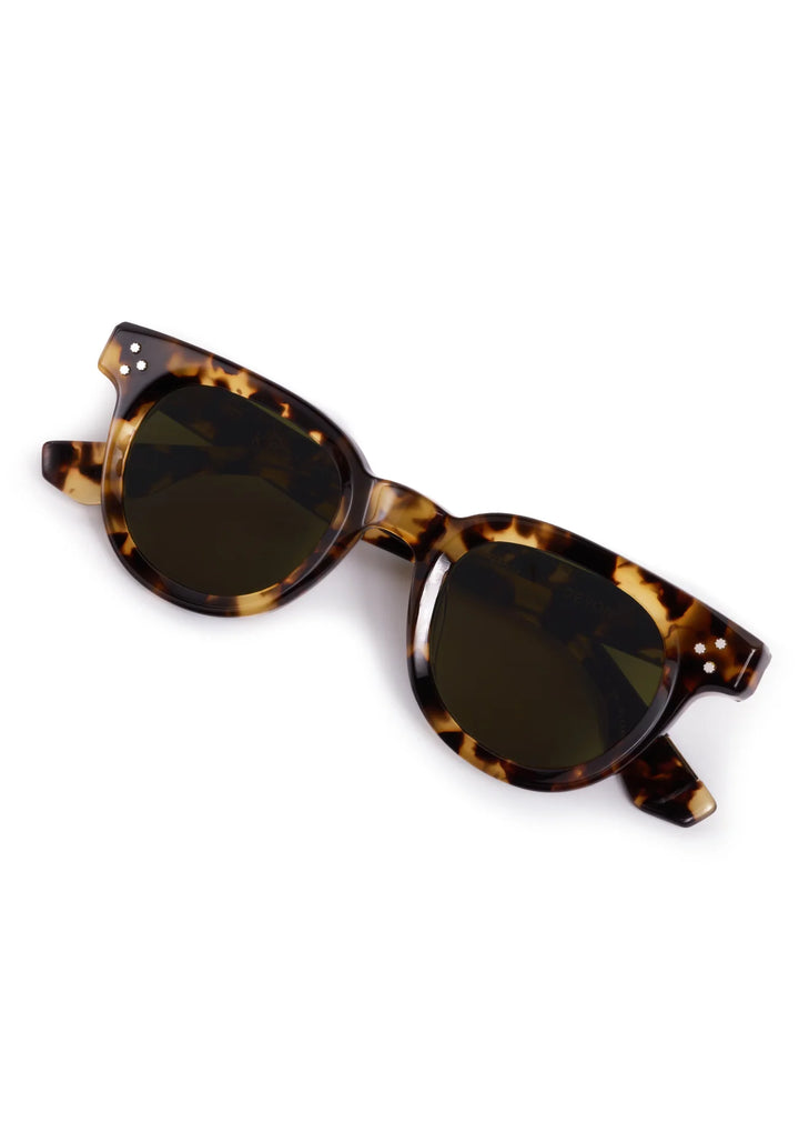 Tortoiseshell sunglasses with dark lenses on a white background
