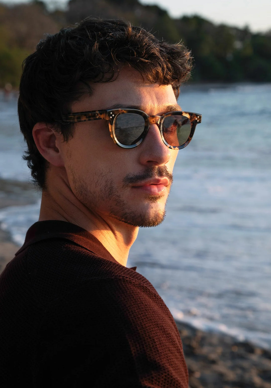 Man wearing sunglasses with a blurred natural background
