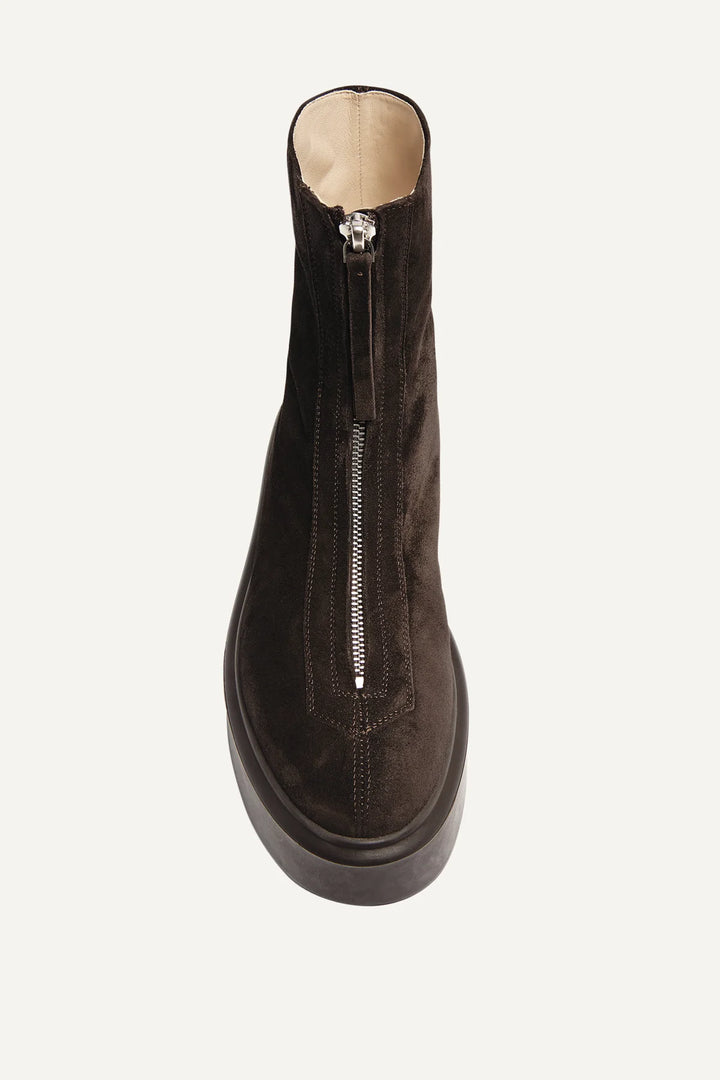 Brown suede boot with a silver zipper on a white background