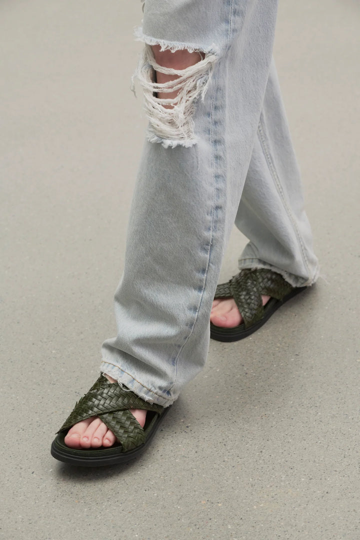 F1462WL74DGN_THE_ROW_BUCKLE_SANDAL_IN_DARK_GREEN_LAWRENCE_COVELL_ON_MODEL