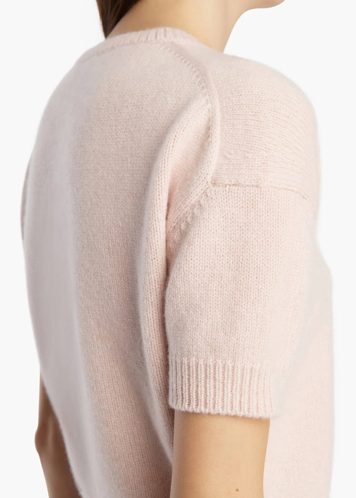 Light pink sweater with short sleeves on a white background
