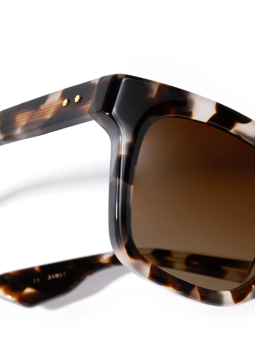 Sunglasses with tortoiseshell frame and brown lenses on a white background