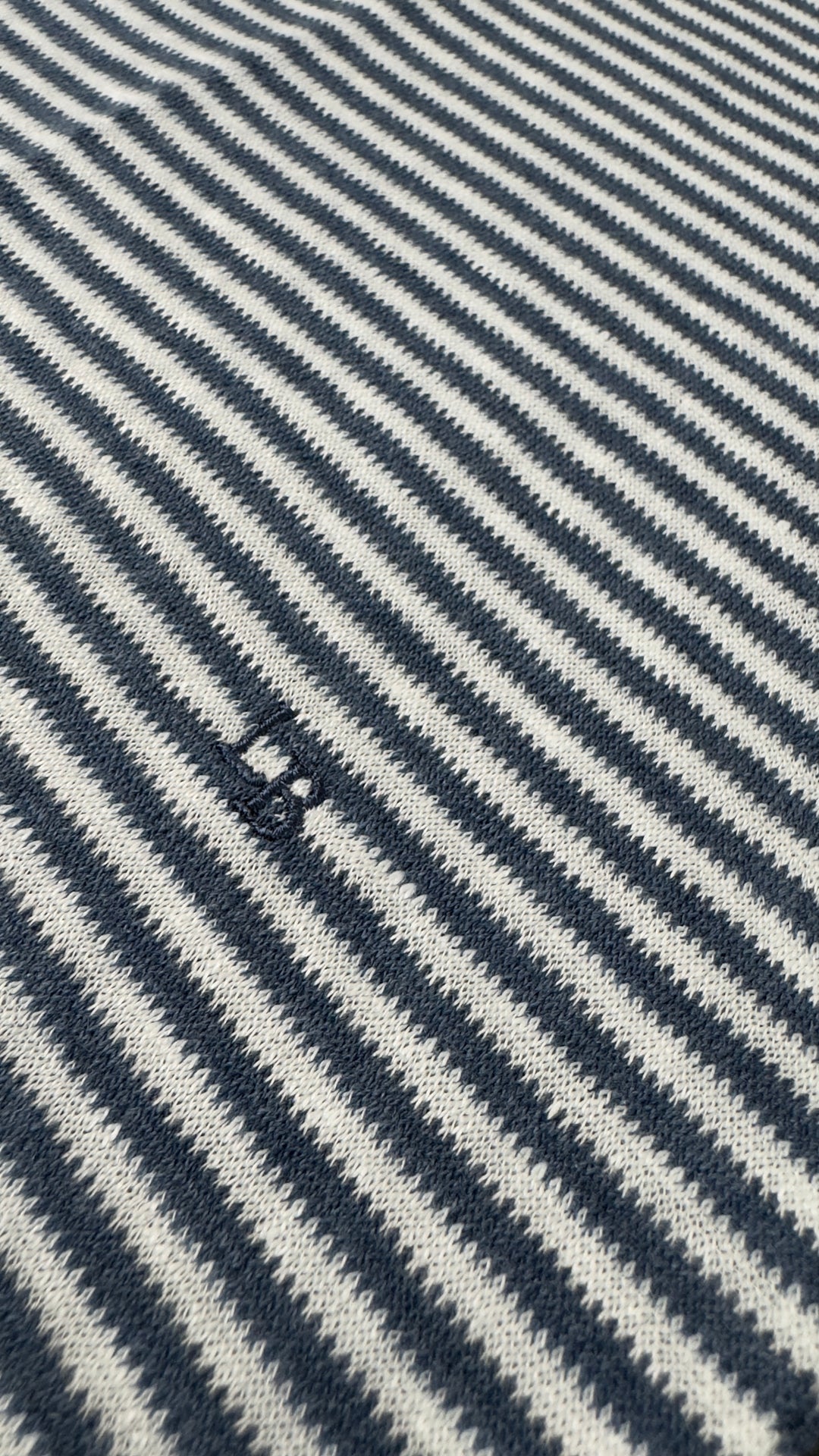 Close-up of a fabric with blue and white diagonal stripes.