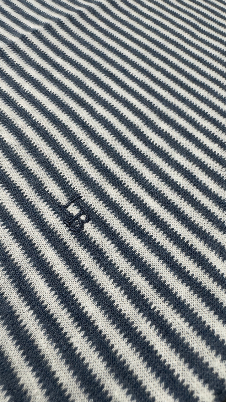 Close-up of a fabric with blue and white diagonal stripes.