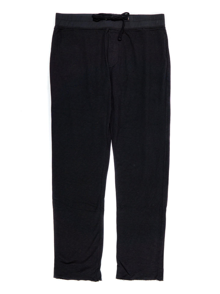 A pair of black French terry sweatpants with a drawstring waist and elastic ankle cuffs.