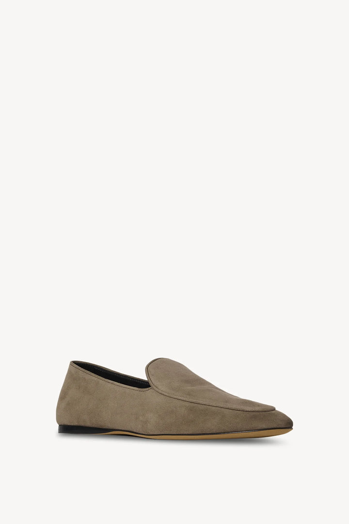 Brown suede loafer on a white background