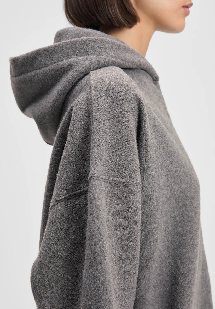 Gray hoodie worn by a person on a light gray background