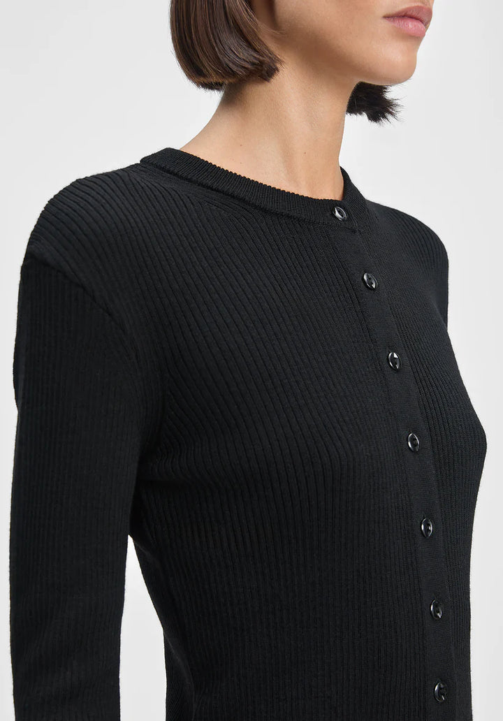 Black ribbed sweater with buttons on a plain background