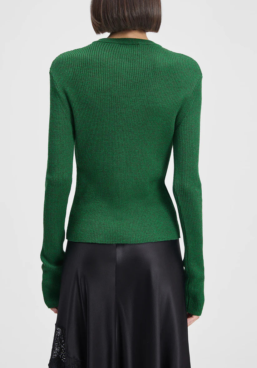 Green ribbed sweater worn by a person on a white background