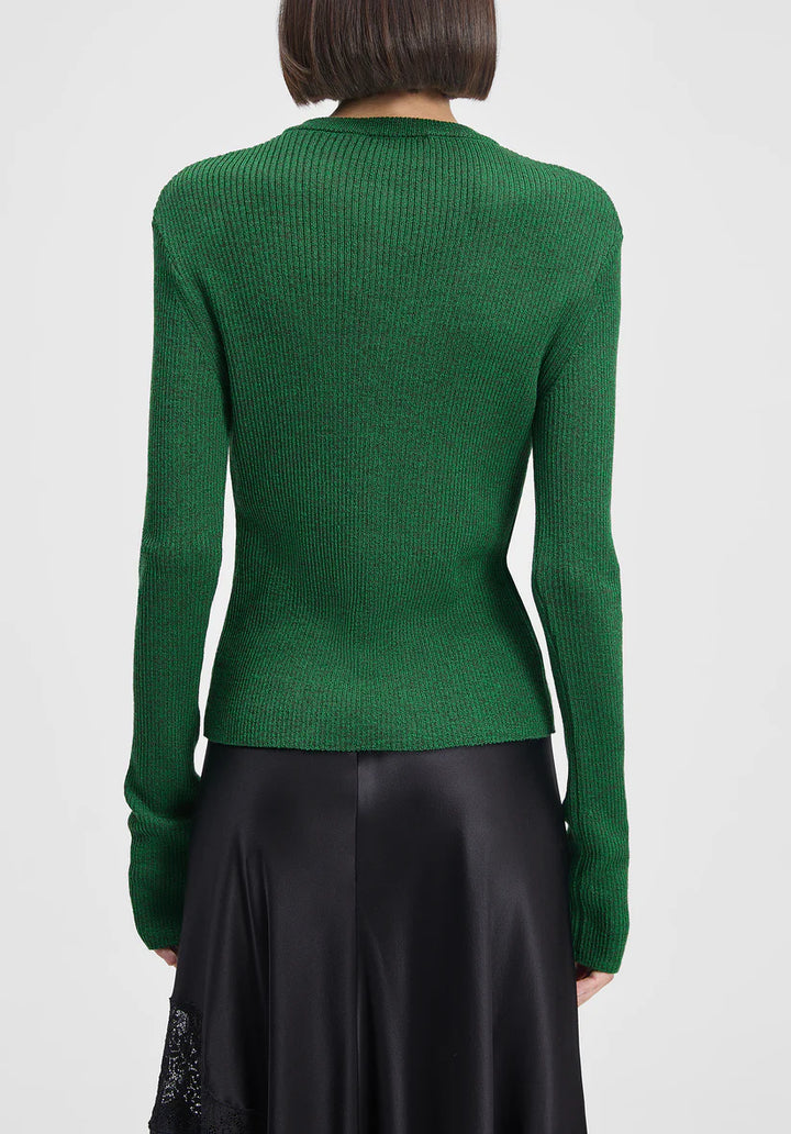 Green ribbed sweater worn by a person on a white background