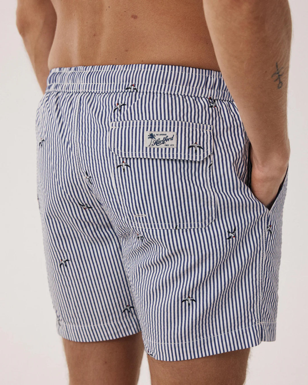 Black and white striped shorts with a brand logo on a plain background