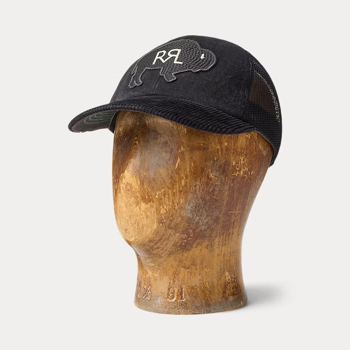 Black cap with a logo on a wooden mannequin head against a white background
