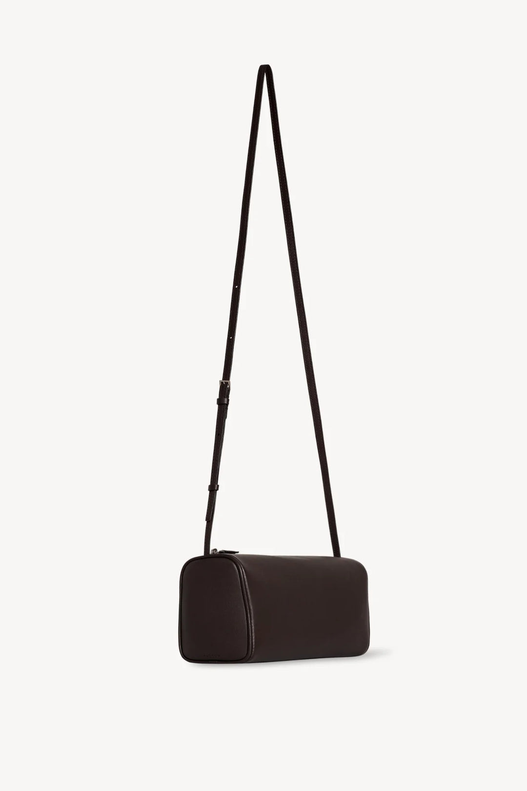 Black handbag with a strap on a light gray background