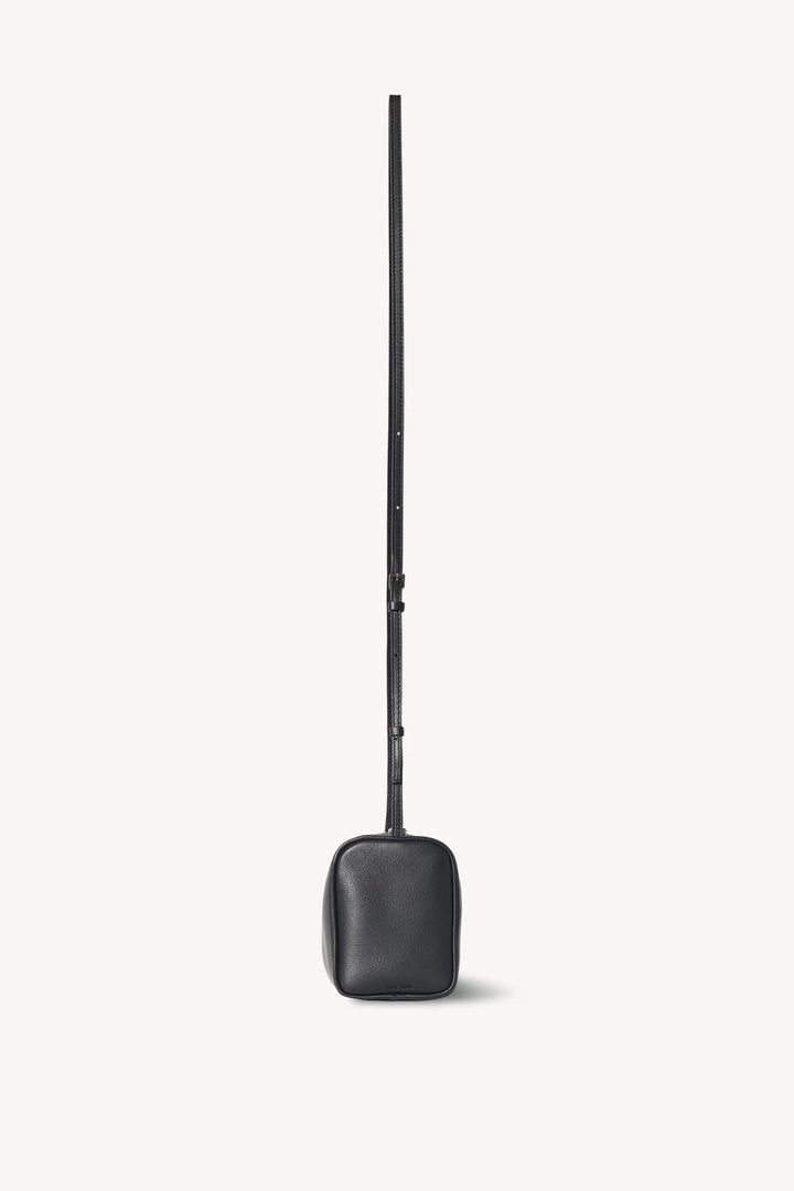 Black leather bag with a long handle on a white background