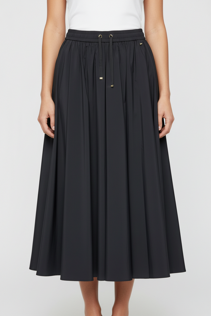 Black skirt worn by a person on a white background