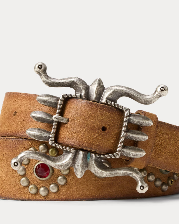 Brown leather belt with silver buckle and decorative elements on a white background