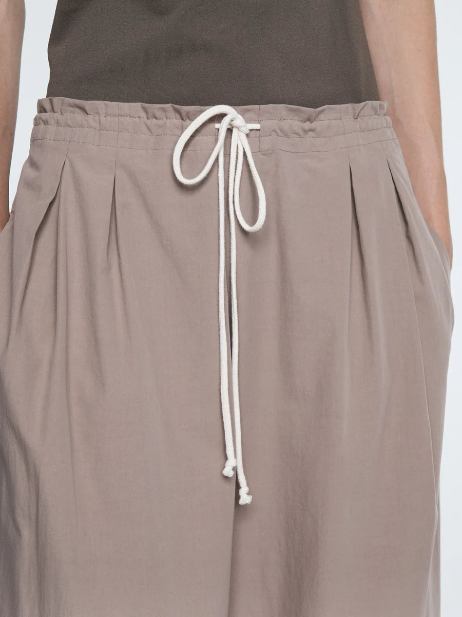 Brown pants with a white drawstring on a plain background