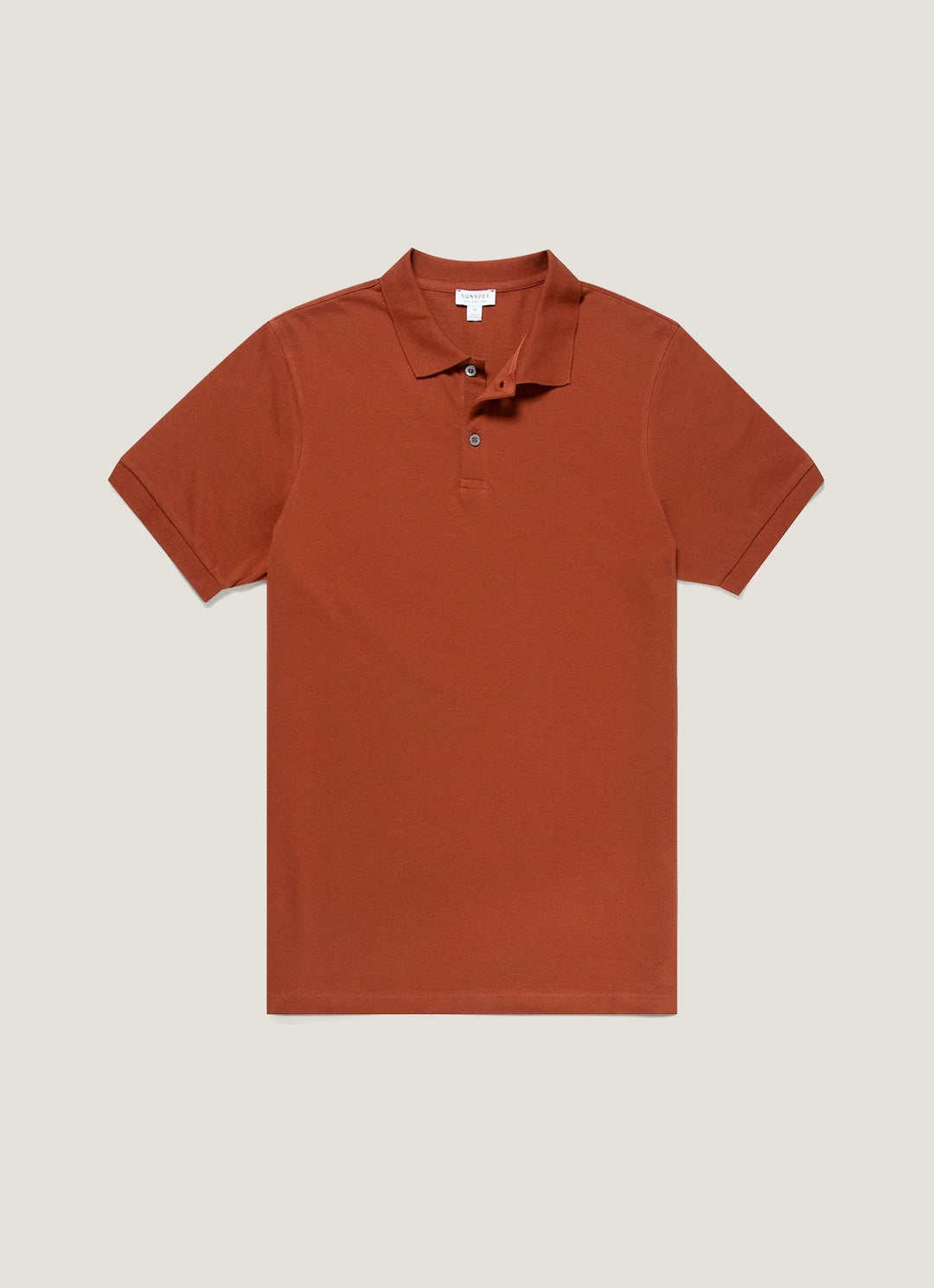 Brown polo shirt on a light beige background