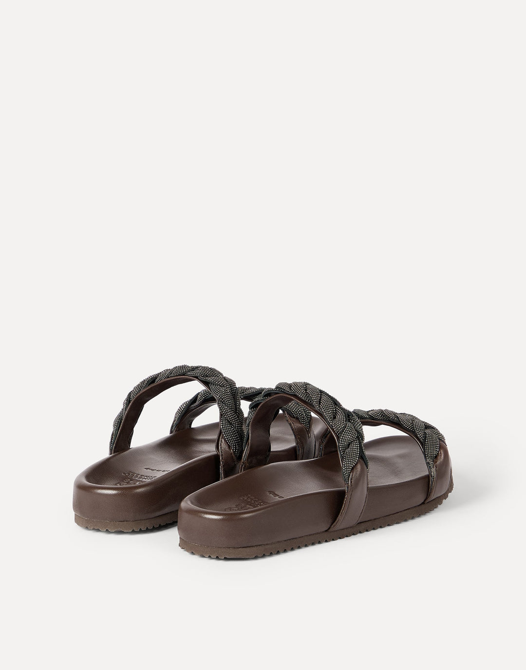 Brown sandals with braided straps on a white background