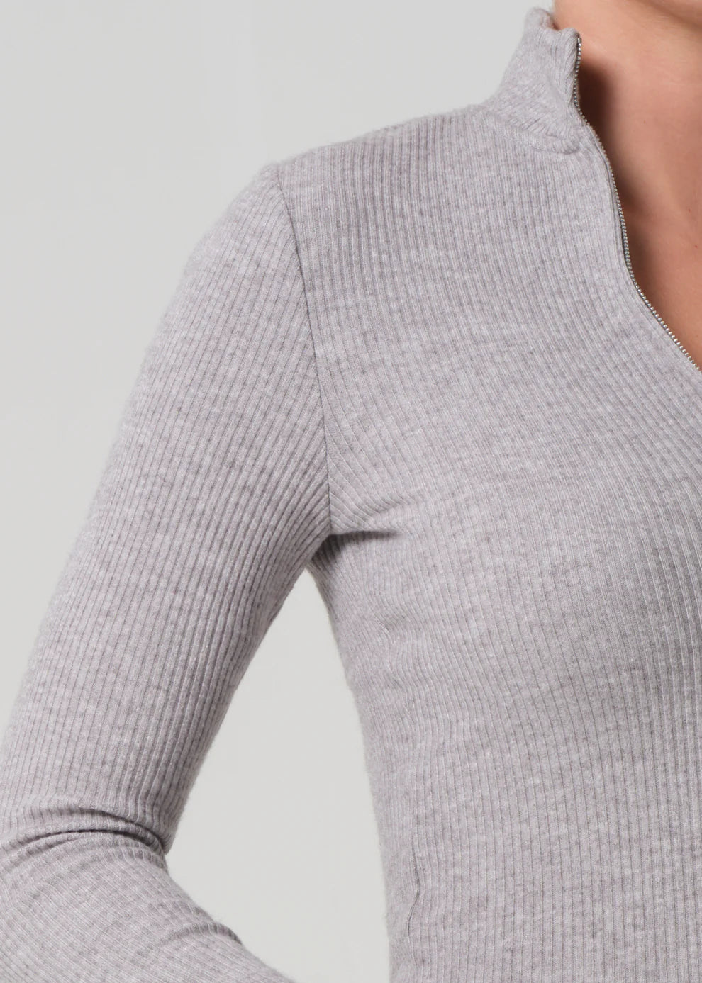 Gray ribbed long-sleeve top on a plain background