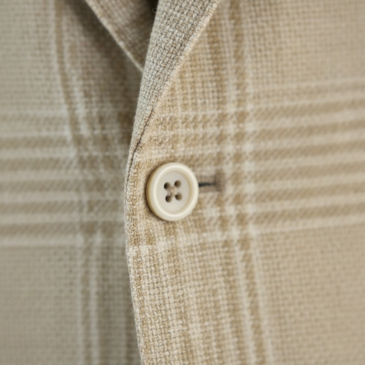 Close-up of a beige plaid fabric with a button