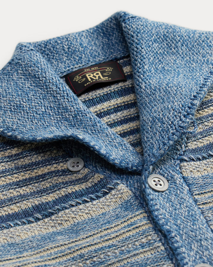 Close-up of a blue and gray striped shirt with a brand label on a white background