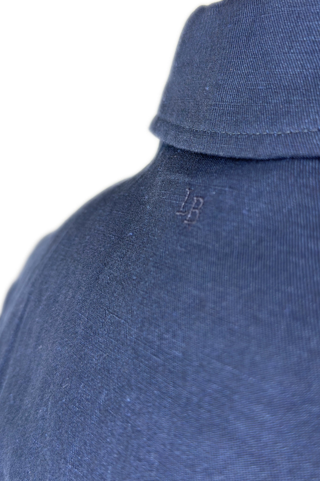 Close-up of a blue garment with a logo on a white background