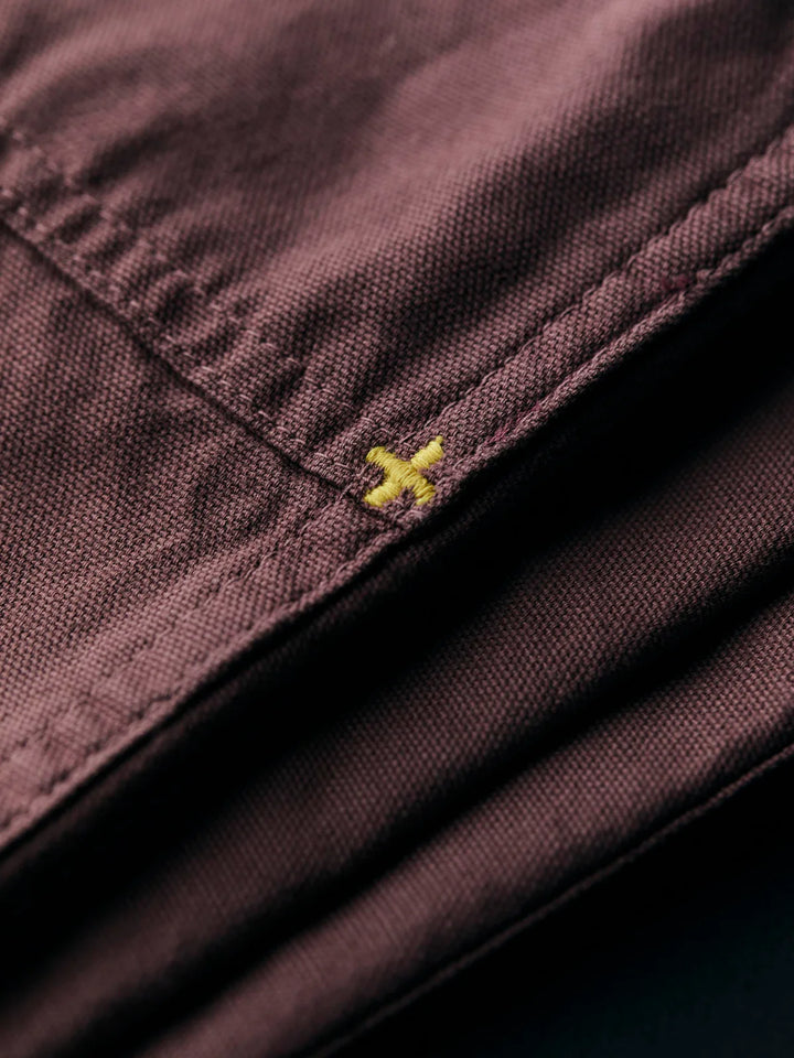 Close-up of a dark fabric with a yellow logo on a black background