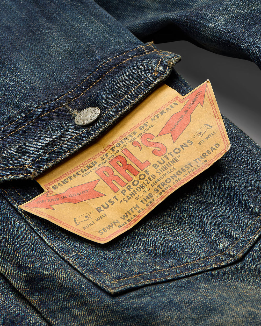 Close-up of a denim pocket with an RRL's button label.