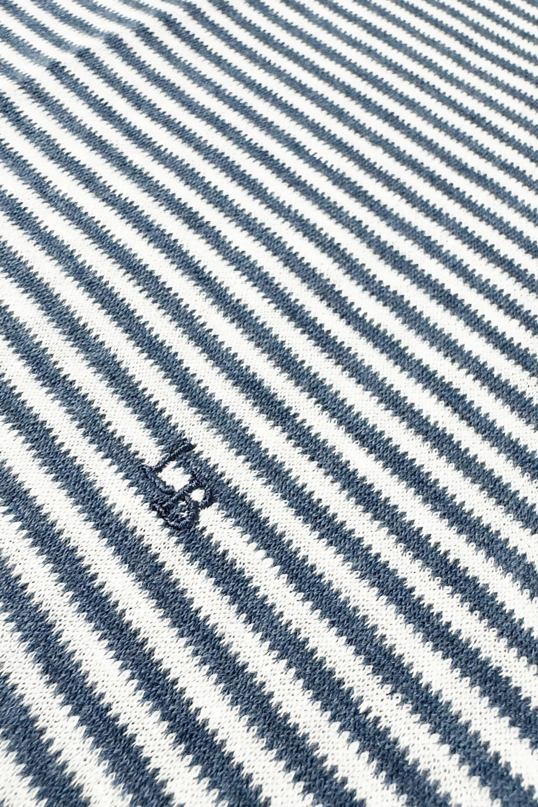 Close-up of a fabric with blue and white diagonal stripes.