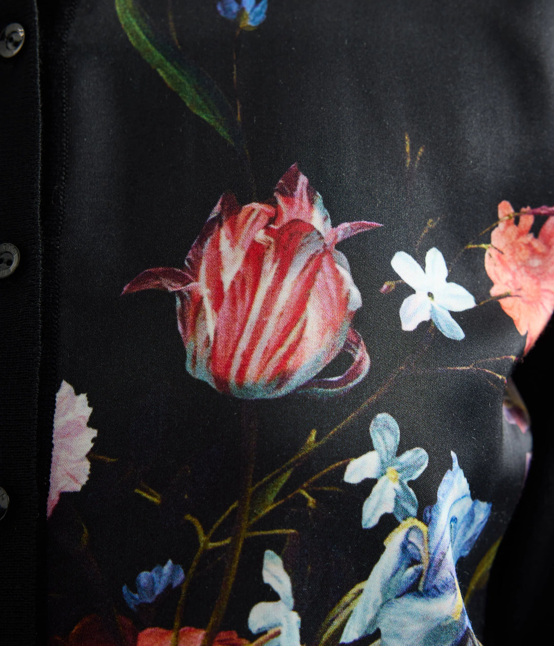 Close-up of a floral pattern with red and white flowers on a dark background