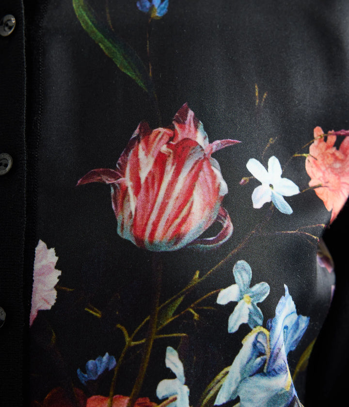 Close-up of a floral pattern with red and white flowers on a dark background