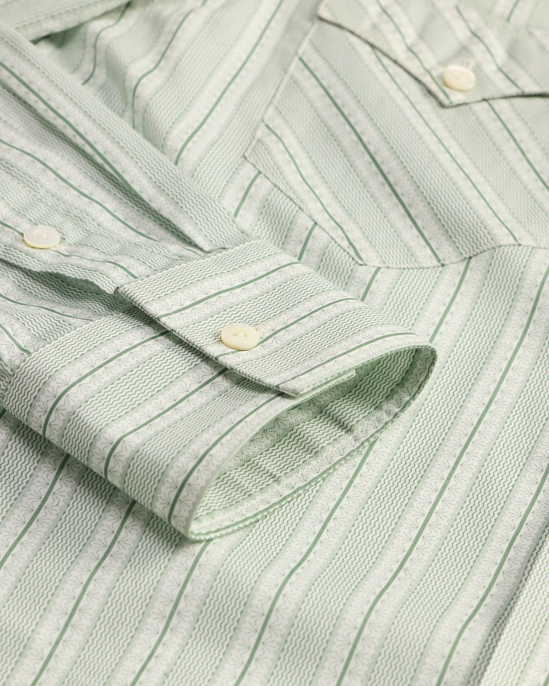 Close-up of a green striped shirt with button details