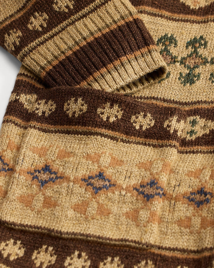 Close-up of a knitted sweater with a patterned design on a white background