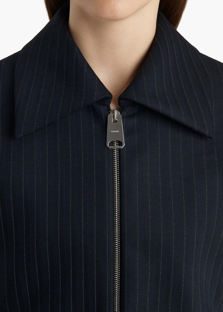 Close-up of a navy pinstripe suit with a zipper on a white background
