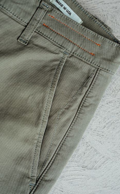 Close-up of a pair of pants with a 'Made in USA' label on a textured surface
