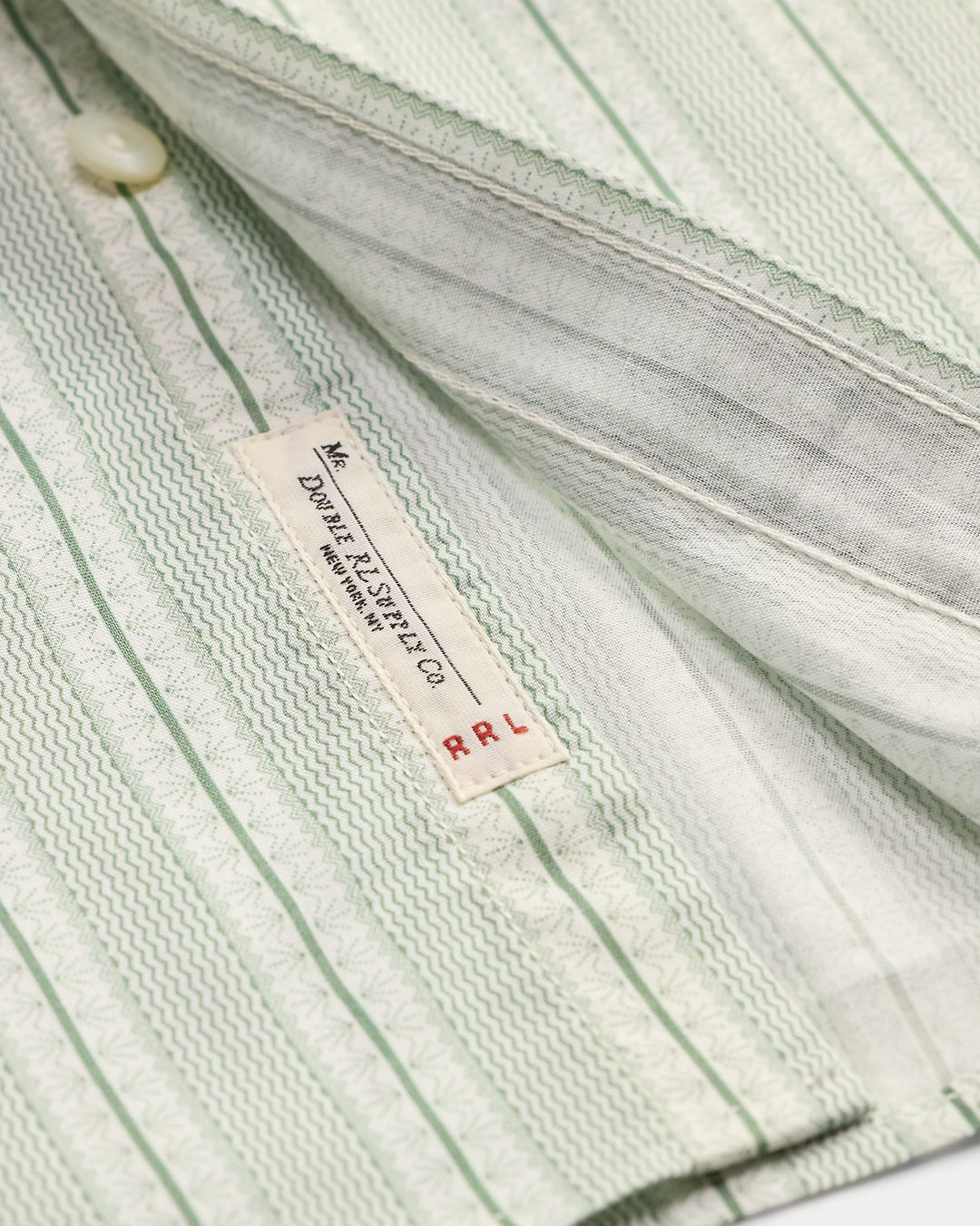 Close-up of a striped shirt with a label on a white background
